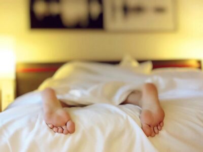 Person Lying on Bed Covering White Blanket