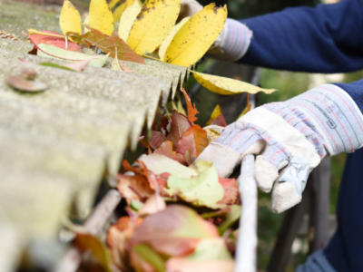 Residential Roofing Service showing cleaning out gutters.