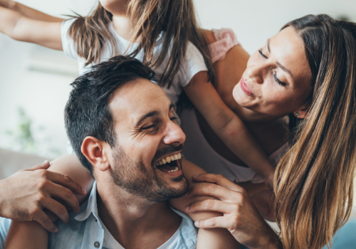 Happy family enjoying time together at home, representing a healthy living environment.