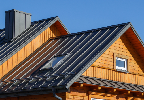 Close-up of a metal roof on a wooden house, showcasing architectural sheet metal work by Story Roofing.